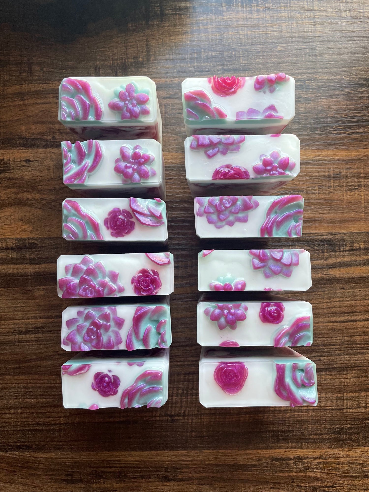 Handmade soap topped with green and purple succulent embeds
